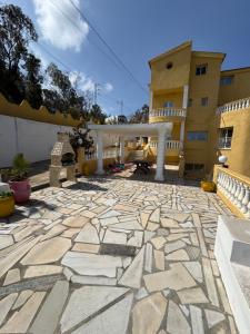 a stone patio in front of a building at Villa Belle-Vue in Tabarka