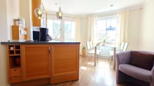 a kitchen and living room with a couch and a table at Residenz am Yachthafen 14 in Grömitz +20 photos