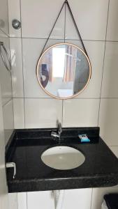 a bathroom with a sink and a mirror at Casa jatobá in Petrolina +10 photos