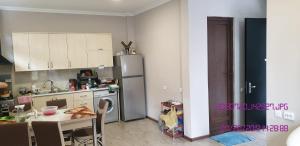 a kitchen with a refrigerator and a table in it at SHEKVETILI s in Kokotauri