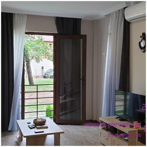 a living room with a door to a patio at SHEKVETILI s in Kokotauri