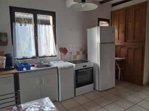 a kitchen with a white refrigerator and a sink at le gite d'Eliane in Masevaux