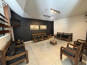 a living room with wooden furniture and a tv at Canas Gold Praia Hotel in Florianópolis +33 photos