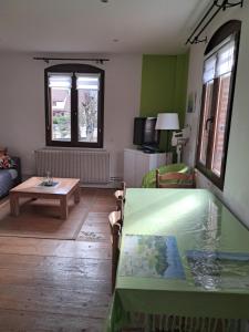 a living room with a table and a couch at le gite d'Eliane in Masevaux