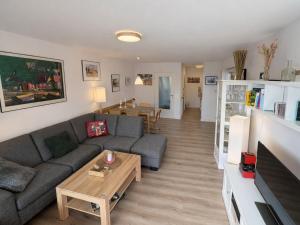 a living room with a couch and a table at Sand & Siel Dangast in Dangast +14 photos