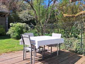 a white table and chairs on a wooden deck at le gite d'Eliane in Masevaux
