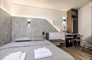a bedroom with a bed with two white towels at Coolplay house in Bangkok