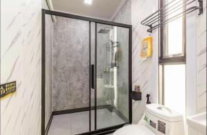 a glass shower in a bathroom with a toilet at Coolplay house in Bangkok +34 photos