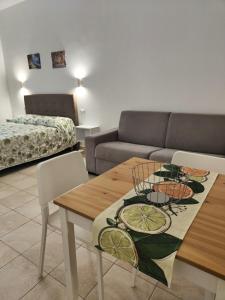 a living room with a table and a couch at M&C Home in Letojanni