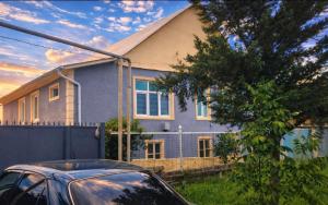 a house with a car parked in front of it at Warm Welcome Ivanovka in İvanovka