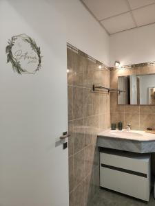 a bathroom with a sink and a shower at M&C Home in Letojanni