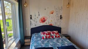 a bedroom with a bed with two pillows on it at Central Riverside Apartments in Jēkabpils +74 photos
