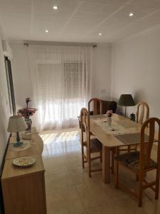 a dining room with a table and chairs and a room at Casa Ingrid in San Fulgencio