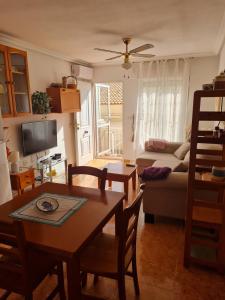 a living room with a table and a couch at Casa Ingrid in San Fulgencio