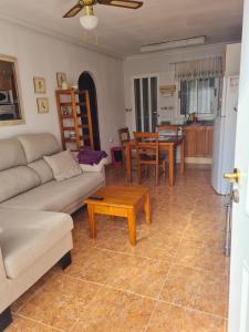a living room with a couch and a table at Casa Ingrid in San Fulgencio +7 photos