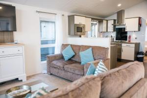 a living room with a couch and a kitchen at Quayside in Christchurch