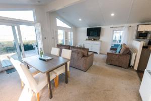 a living room with a dining room table and chairs at Quayside in Christchurch
