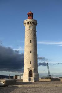 a white lighthouse with a red top on top of it at DOMITYS - Le Ruban d'Azur in Sète