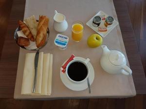 a breakfast tray with a cup of coffee and toast at DOMITYS - Le Ruban d'Azur in Sète