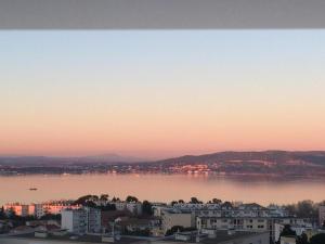 a view of a large body of water at sunset at DOMITYS - Le Ruban d'Azur in Sète