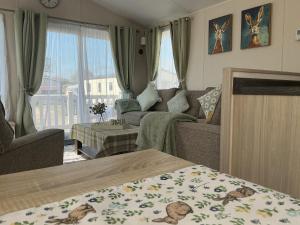 a living room with a couch and a living room with at Hares Haven pet friendly sleeps 6 in Patrington +76 photos