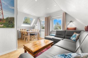a living room with a couch and a table at Up Böhn in Krummhörn