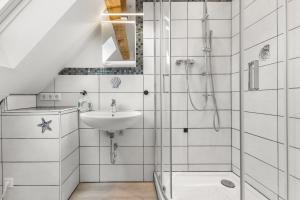 a bathroom with a shower and a sink at Up Böhn in Krummhörn +7 photos
