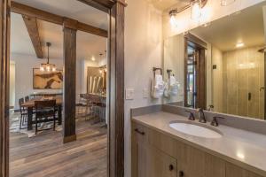 a bathroom with a sink and a dining room at Mountain Lake Condo - Unit 102B in Big Sky +30 photos