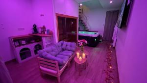 a purple living room with a couch and a table at Luana SPA Boussois in Boussois