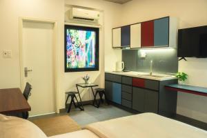 a room with a kitchen with a sink and a window at Fair Dinkum Stay District 1 in Ho Chi Minh City