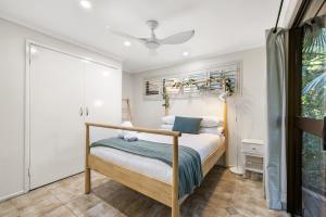 a bedroom with a bed and a ceiling fan at The Bamboo Base at Buderim in Buderim