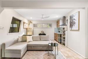 a living room with a couch and a table at The Bamboo Base at Buderim in Buderim