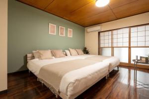 a large white bed in a room with a window at Staylinks Nara Kitamachi in Nara +61 photos