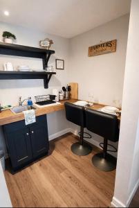 a kitchen with a counter with two chairs and a sink at Western Studio in Houston +12 photos