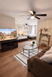 a living room with a couch and a flat screen tv at Western Studio in Houston