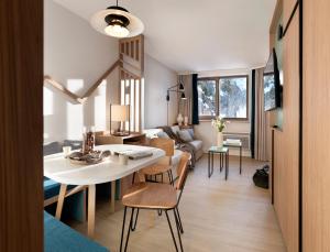 a living room with a white table and chairs at Résidence Pierre & Vacances Capella in Avoriaz