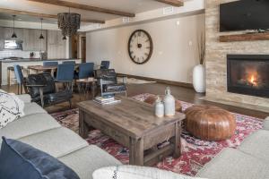 a living room with a couch and a fireplace at Mountain Lake Condo - Unit 401B in Big Sky
