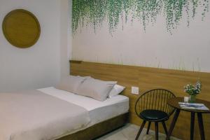 a bedroom with a bed and a table and a mirror at Fair Dinkum Stay District 1 in Ho Chi Minh City