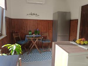 a kitchen with a table and a refrigerator at Gravitacija West in Tolmin +12 photos