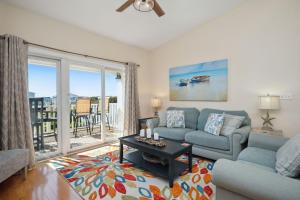 a living room with a couch and a table at Sea Tales by Oak Island Accommodations in Oak Island