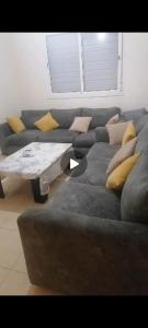 a living room with a couch and a coffee table at سيدي رحال الشاطئ in Sidi Rahal