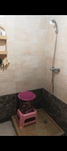 a bathroom with a pink toilet and a shower at سيدي رحال الشاطئ in Sidi Rahal