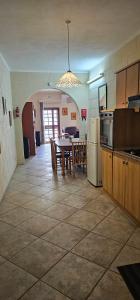a kitchen and dining room with a table and refrigerator at Quiet, spacious 3 bedroom 2 bathroom apartment in Għajnsielem