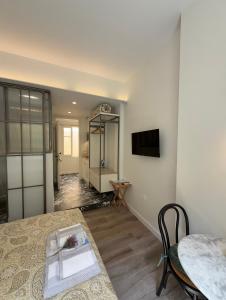a living room with a table and a dining room at MUSES LUXURY SUITES in Corfu