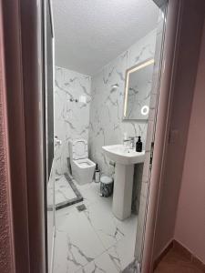 a bathroom with a toilet and a sink at Dejani Guest House in Pogradec +29 photos