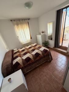 a bedroom with a bed and a tiled floor at Casa Rural La Abejuela in Abejuela