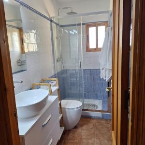 a bathroom with a sink and a toilet and a shower at Casa Rural La Abejuela in Abejuela