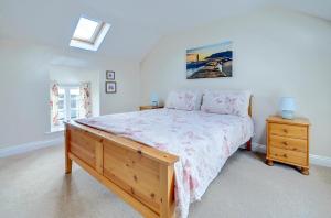 a bedroom with a large bed with a wooden dresser at 2 Bed in Pickering oc-y012 in Pickering