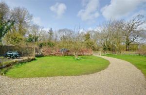 a garden with a gravel path and a grass field at 2 Bed in Pickering oc-y012 in Pickering