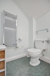 a white bathroom with a toilet and a window at 2 Bed in Pickering oc-y012 in Pickering +3 photos